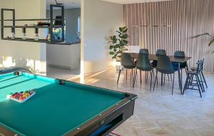 a living room with a pool table and a dining room at Nice Home In storp With Kitchen in Åstorp