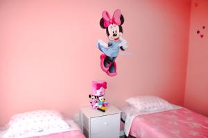 a bedroom with a mickey mouse wall decal at *Home in davenport Cheerful 5-bedroom with pool in Davenport