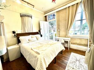 a bedroom with a bed and a large window at Fleur De Lis Mansion in New Orleans