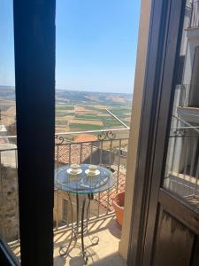 a balcony with a table and a view at Salemi San Biagio townhouse in Sicily in Salemi