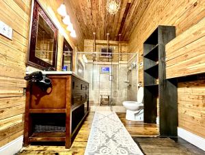a bathroom with a toilet and a wooden wall at Fleur De Lis Mansion in New Orleans +67 photos
