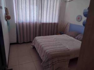 a bedroom with a bed and a window with curtains at Casa de playa, Bejuco Costa Rica in Bejuco +19 photos