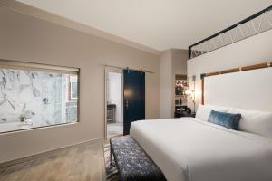 a bedroom with a large bed and a window at JW Marriott Savannah Plant Riverside District in Savannah