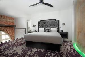 a bedroom with a large bed and a ceiling fan at JW Marriott Savannah Plant Riverside District in Savannah
