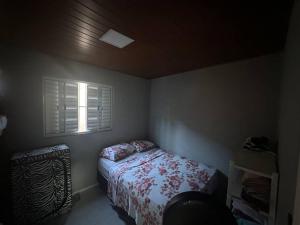 a small bedroom with a bed and a window at Casa beiramar Provetá IlhaGrande in Angra dos Reis