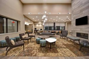 a lobby with chairs and tables and a fireplace at Residence Inn by Marriott Cincinnati Northeast/Mason in Mason