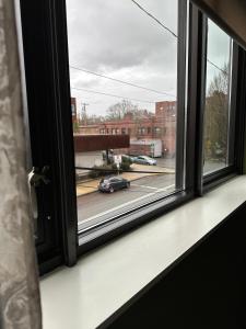 an open window with a view of a street at VioletSuitesPDX in Portland