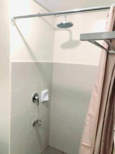 a bathroom with a shower with a shower curtain at Avida Atria Tower I Cozy Condo Great Location in Iloilo City