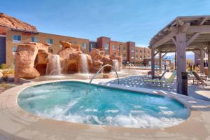 a swimming pool with a water park with a fountain at SpringHill Suites by Marriott Moab in Moab