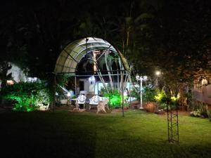 a gazebo in the middle of a yard at night at RESIDENCIA-UNIV in Ciudad del Este