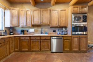 a kitchen with wooden cabinets and stainless steel appliances at Balloon fiesta home in Albuquerque