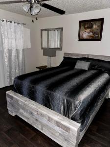 a bedroom with a large bed with a black blanket at elegant stylish living in Arlington