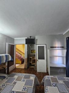 Habitación con 2 camas y habitación con puerta en Hostal Copa Arica en Arica