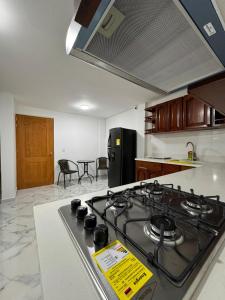 a kitchen with a stove top oven in a kitchen at HOSPEDAJE TRIANON in Envigado