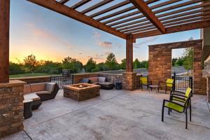 an outdoor patio with a fireplace and a fire pit at SpringHill Suites by Marriott Denver West/Golden in Lakewood