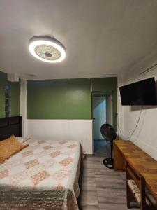 a bedroom with a bed and a flat screen tv at Hostal Copa Arica in Arica