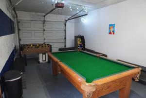 a room with a pool table in a garage at House of Blues-3 Bedrooms+GameRoom in Orlando