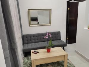 a living room with a couch and a table at 935 Lodge San José in San José