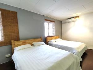Postel nebo postele na pokoji v ubytování Mori Jonker Homestay