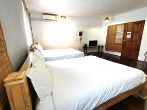 Postel nebo postele na pokoji v ubytování Mori Jonker Homestay