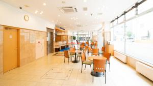 a dining room with tables and chairs in a building at Toyoko Inn Hokkaido Asahikawa Ekimae Ichijo dori in Asahikawa