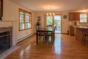 a kitchen and dining room with a table and a fireplace at Perfect vacation getaway! in Barnstable