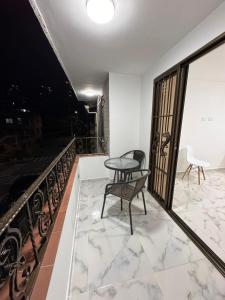 a balcony with a table and a bench on a balcony at HOSPEDAJE TRIANON in Envigado