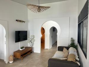 een woonkamer met een bank en een tv bij Appartement 2 chambres Sainte-Luce in Sainte-Luce