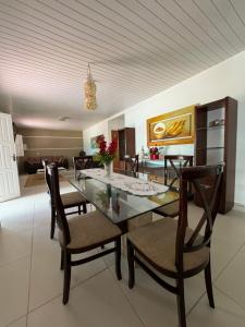 a dining room with a glass table and chairs at My House Canoa in Canoa Quebrada