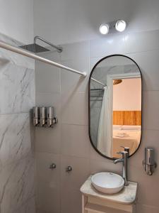 a bathroom with a sink and a mirror at URBAN 483 in La Falda