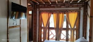 an open window with curtains in a room at Villa Ester Hostel Vereda Cay in Ibagué