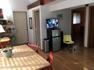 a living room with a table and a television at Whitaker 5 bdrm Daily-Weekly-Monthly in Eugene