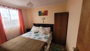 a small bedroom with a bed and a window at Casas Rocamar in Totoralillo +71 photos