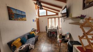 a living room with a couch and a table at Casas Rocamar in Totoralillo