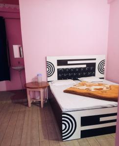 a bedroom with two twin beds and a table at Hotel diyaraj barkot sarukhet in Barkot