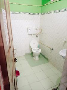 a bathroom with a toilet and a sink at Hotel diyaraj barkot sarukhet in Barkot