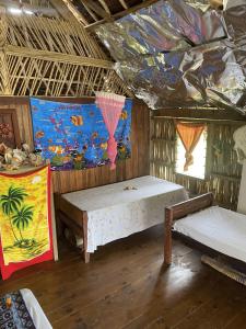 a room with two beds and a painting on the ceiling at Port-Olry Beach Bungalows Chez Louis in Port-Olry