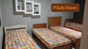 una habitación con dos camas y una casita en Casa de Praia com Piscina em Peruíbe, en Peruíbe