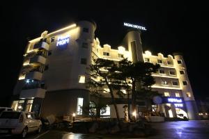 a hotel with a car parked in front of it at night at MGM Hotel in Gangneung