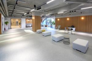 a large room with white tables and chairs in it at MGM Hotel in Gangneung