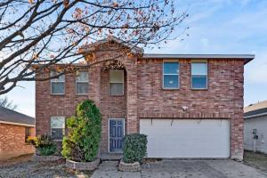 a brick house with a white garage at 2 King ! Newly renovated w/8 beds sleeps upto 16 in Anna