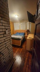 a bedroom with a bed and a brick wall at 4 Bedroom Few Blocks From Beach , Tropicana Casino , Stockton University , Bay in Atlantic City