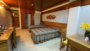 a room with two ottomans in a room at CITI HOTEL in Hilongos