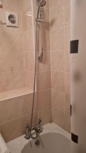 a shower in a bathroom with a tub at 3BED Maisonette Near CityCentre in Birmingham