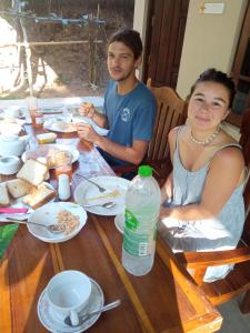 un hombre y una mujer sentados en una mesa comiendo comida en Appu Villa, en Tangalle