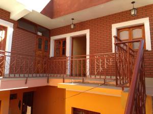 a balcony of a house with a staircase at HOSTAL DOÑA BERTA in Humahuaca