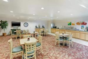 a restaurant with tables and chairs and a kitchen at Quality Inn Payson I-15 in Payson