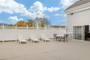 a patio with chairs and tables and a white fence at Quality Inn Payson I-15 in Payson