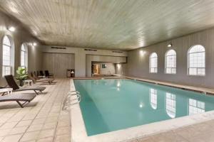 a large swimming pool in a large room with chairs at Quality Inn Payson I-15 in Payson
