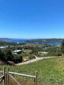 a view from a hill with a fence at Cabaña Alto de Punahuel in Dalcahue